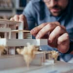 Architect with model of a house
