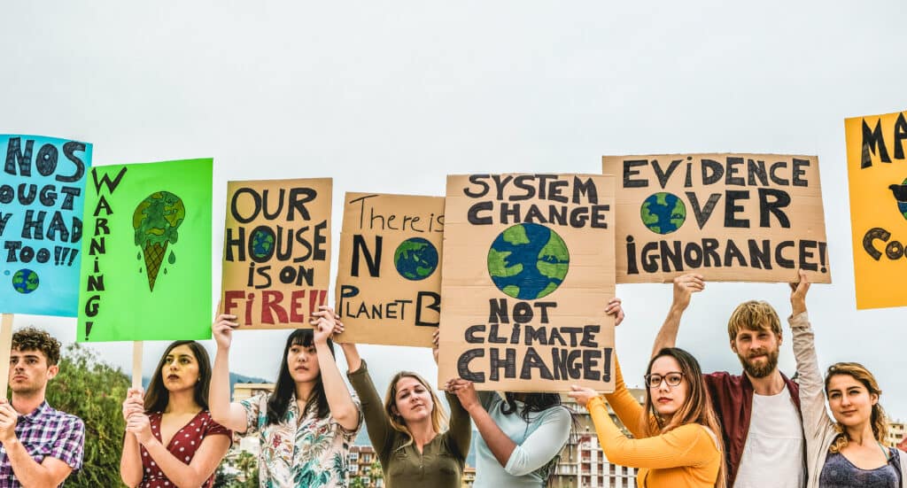 Young people protesting climate change with placards