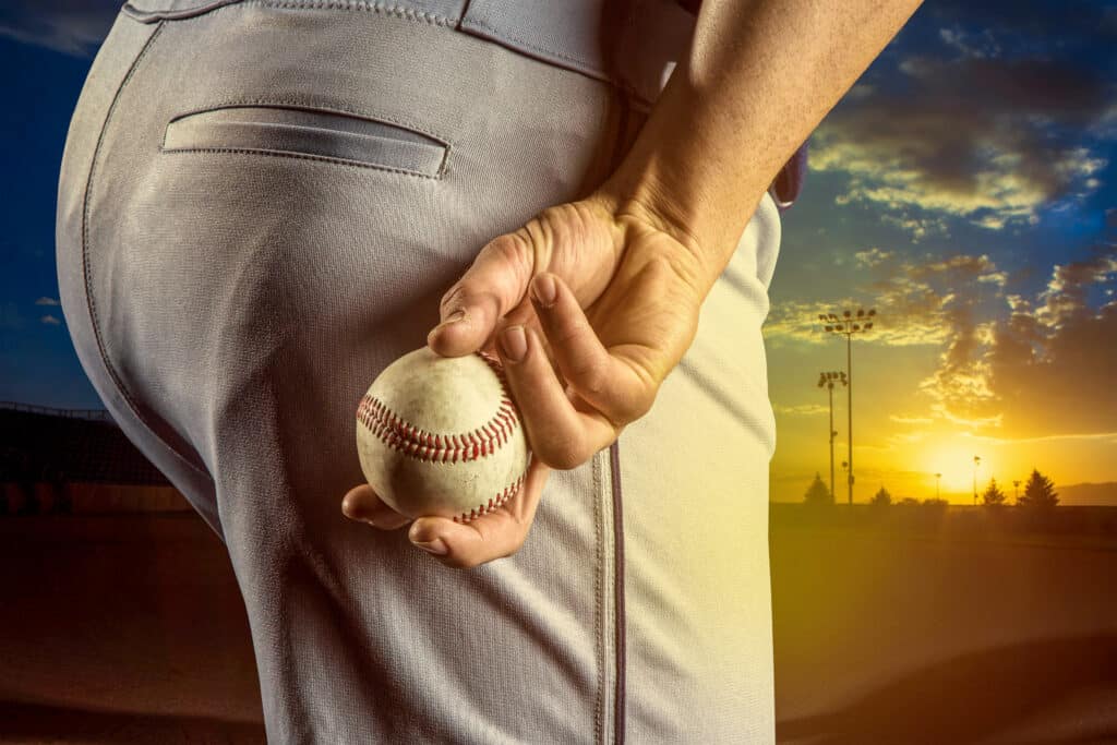 Pitcher hiding his hand and preparing to throw a curve ball