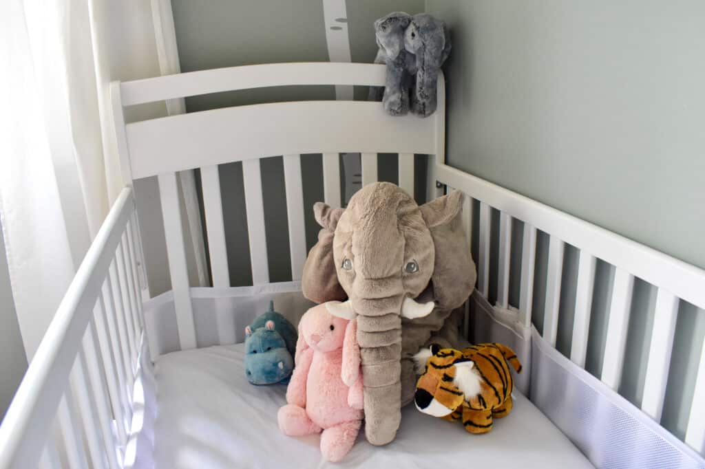 Stuffed toy elephant in a baby's crib
