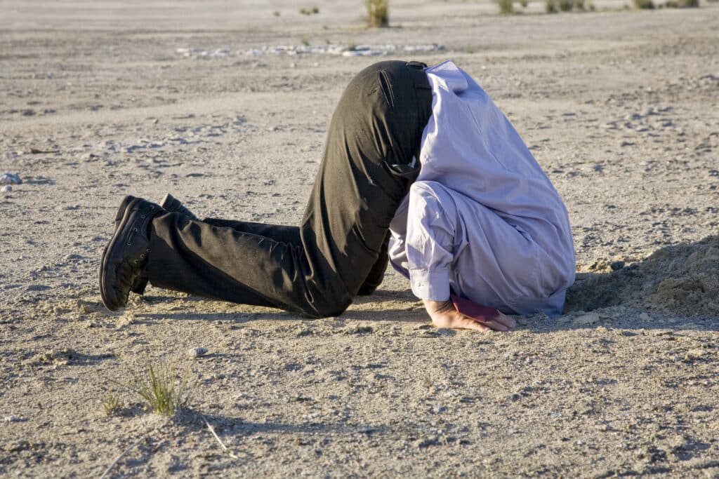 Man with head in the sand