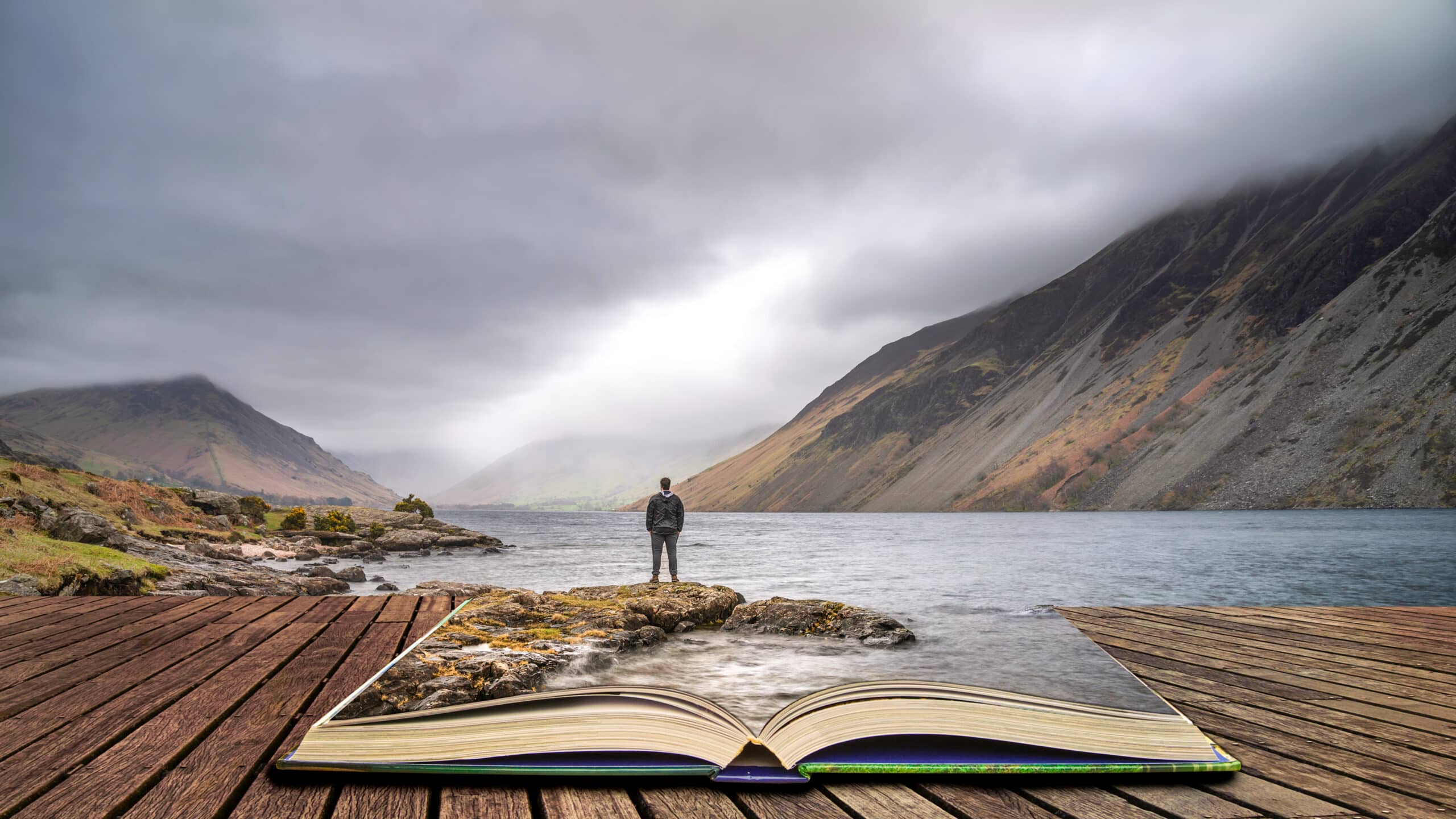 Fantasy image of man at lakeside with waters flowing in/out from a large open book at the shore