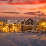 Village winter scene - shot from surrounding higher elevation with lights on the in the village at dusk